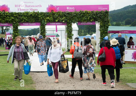 People walking to & from entrance & exit, coming & going, arriving & leaving - busy showground, RHS Chatsworth Flower Show, Derbyshire, England, UK. Stock Photo