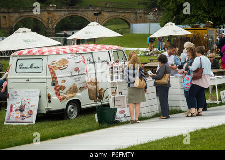 People standing by Bonne Maman vintage van food stall buying & looking at produce display - RHS Chatsworth Flower Show, Derbyshire, England, UK Stock Photo