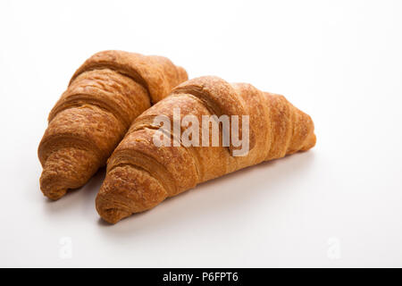 two large croissants on grey background Stock Photo