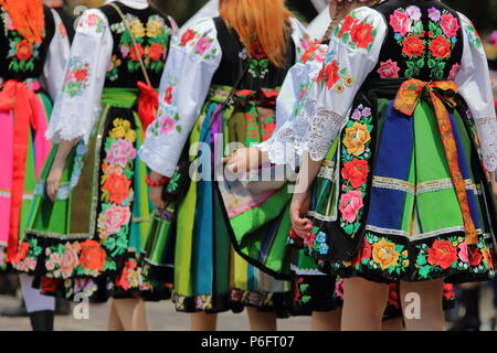 Local women. girls dressed in traditional regional folk costumes from Lowicz region, Poland, during annual celebration of Corpus Christi  procession. Stock Photo