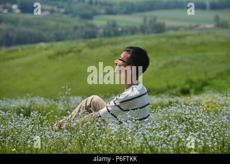 Enjoying the wildflowers in the Grasslands of Nalati, Xinjiang, China Stock Photo