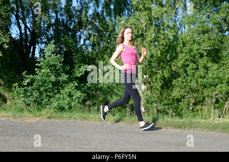 Petite female running in the forest. Acrive woman running on the