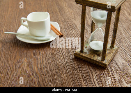 Hourglass on the Oak table as time passing concept for business deadline, urgency and running out of time. Stock Photo