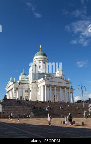 Tourists in front of the Helsinki Cathedral (Helsingin Tuomiokirkko) in Finland, in the summer. It was built in 1830-1852 in neoclassical style. Stock Photo