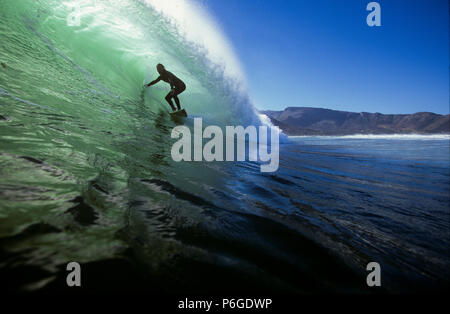 Surfing green tube wave in Cape Town, South Africa Stock Photo