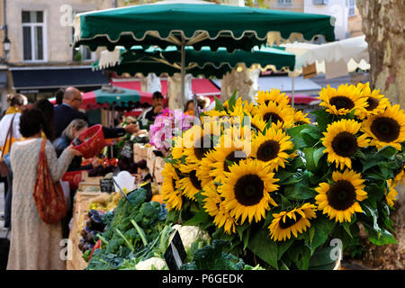 Aix-en-Provence, France - October 18, 2017 : people buying vegetables and flowers in the central provence market Stock Photo