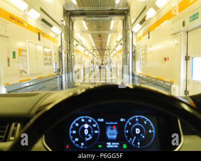 Driving a Range Rover into the Eurotunnel Le Shuttle train. Photograph taken from drivers point of view Stock Photo