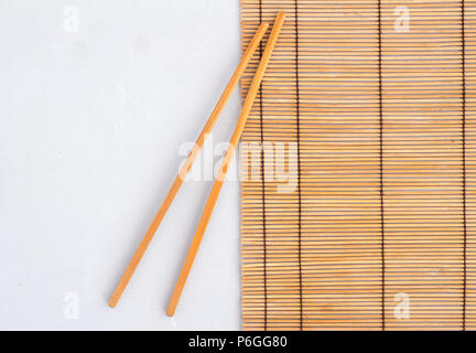 Chopsticks on reed mat - top view photo with space for text Stock Photo