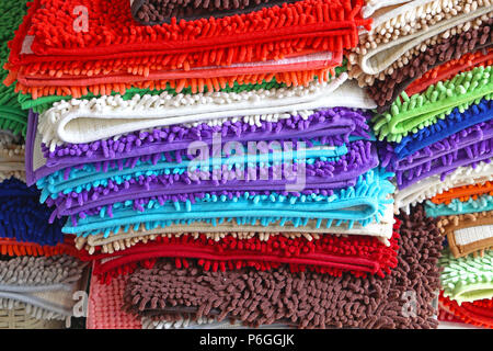 Pile of colorful bathroom rugs and floor mats Stock Photo