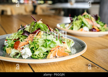 Business lunch two plates of salad on the table nobody side view close-up Stock Photo