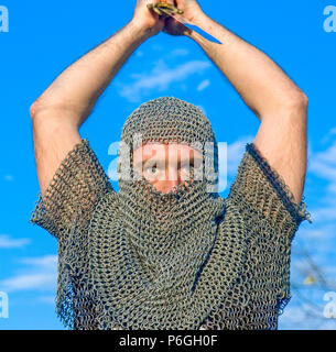 Knight warrior wearing armour and hold on a sword Stock Photo