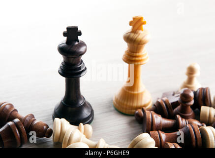 chess duel of two kings and other chess pieces on a grey background Stock Photo