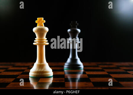 chess duel of two kings on a black background close up Stock Photo