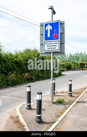 Sign stating Priority Over Oncoming Vehicles Stock Photo