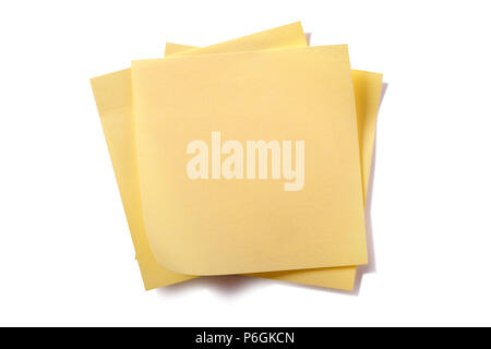 Untidy stack yellow sticky post notes isolated on white Stock Photo