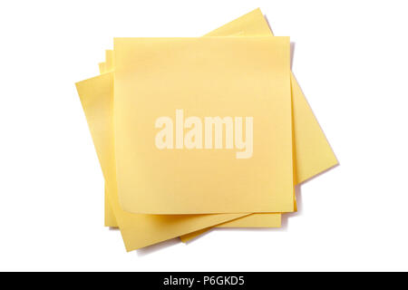 Untidy stack yellow sticky post notes isolated on white Stock Photo