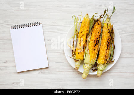 Corn Notepad Grilled corn on the cob with notepad, top view. From above, flat lay ...