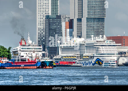 Rotterdam, The Netherlands, May 31, 2018: two large cruiseships are moored on either side of the Nieuwe Maas river, with the Wilhelminapier highrise i