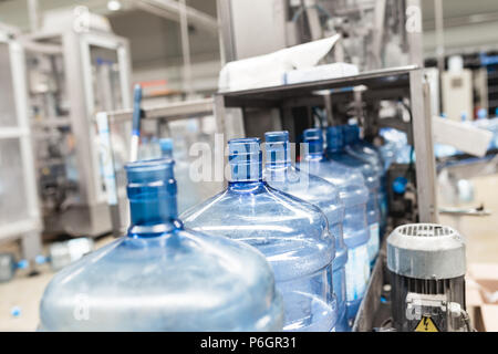 Bottling plant - Water bottling line for processing and bottling pure mineral carbonated water into bottles. Stock Photo