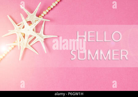 Hello summer with seashells and starfish on pink background. Stock Photo