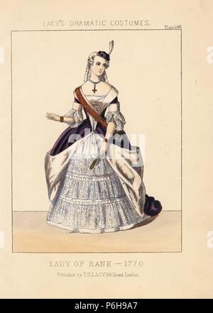 Lady of rank, 1770. She wears a tiny hat with feather, wig, choker with cross, purple dress lined with fur, lace sleeves, sash, and embroidered petticoat. Handcoloured lithograph from Thomas Hailes Lacy's 'Female Costumes Historical, National and Dramatic in 200 Plates,' London, 1865. Lacy (1809-1873) was a British actor, playwright, theatrical manager and publisher. Stock Photo