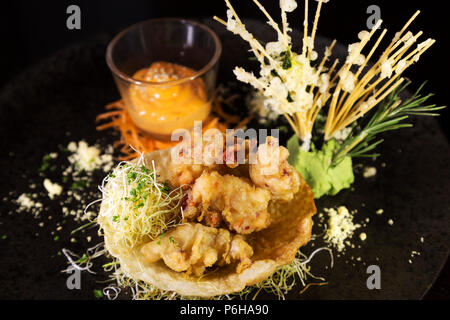 Lobster tempura with Sriracha mayo. The deep fried dish has Asian influences. Stock Photo