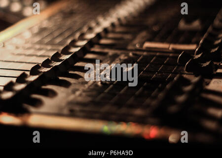 close up view of knobs and sliders of light and sound board console at a concert theater Stock Photo