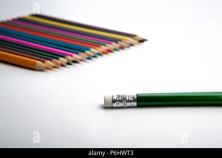 row of colored pencils and simple pencil foreground on white Stock Photo