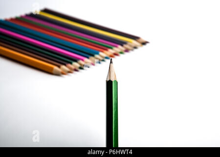 row of colored pencils and simple pencil foreground on white Stock Photo