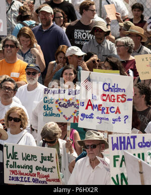 Protesters hold signs in a crowd at the Families Belong Together rally in downtown Asheville, NC, USA Stock Photo