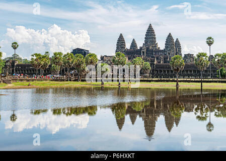 Angkor Wat, Cambodia - November 17, 2017: Tourists are visiting Angkor Wat temple with reflection in the water. It is the largest religious complex in Stock Photo