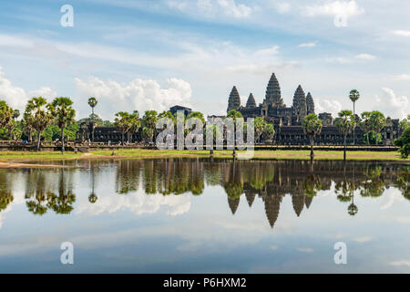 Angkor Wat, Cambodia - November 17, 2017: Tourists are visiting Angkor Wat main temple with reflection in the water. It is the largest religious compl Stock Photo