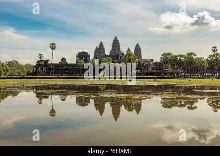 Angkor Wat, Cambodia - November 17, 2017: Tourists are visiting Angkor Wat main temple with reflection in the water. It is the largest religious compl Stock Photo