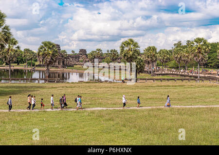 Angkor Wat, Cambodia - November 17, 2017: Tourists at the reflecting pond and the South Library  Library in Angkor Wat. It is the largest religious co Stock Photo