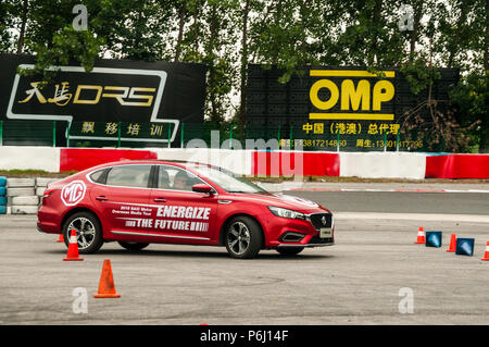 An eMG 6 from Chinese car manufacturer SAIC manoeuvring on a slalom course at the Tianma Race Circuit in Shanghai. Stock Photo