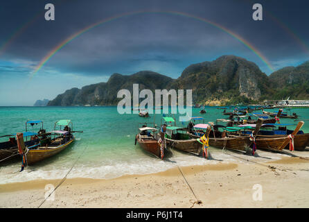 Tonsai Beach bay view with many traditional longtail boats parking and palm seafront in Thailand, Phi Phi island, Krabi Province, Andaman Sea Stock Photo