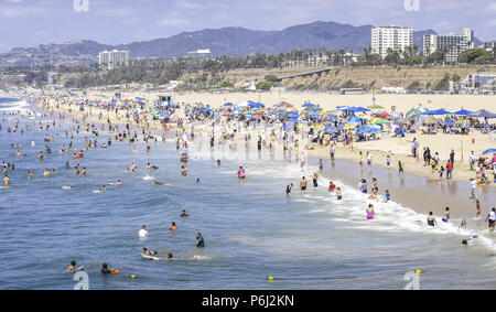 4 September 2016 -  Los Angeles, USA. People swimming in the Pacific Ocean at the coastal city of Santa Monica, enjoying hot weather on the sandy beach Stock Photo