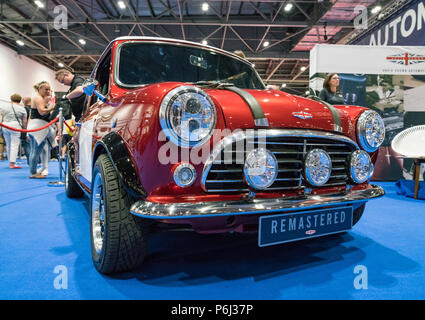 19 May 2018 - London, England. Classic British icon in a modern package, shiny small red modified Mini Remastered by David Brown in London Motor Show. Stock Photo
