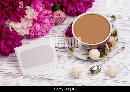 Peony with greeting card teacup and spoon Stock Photo