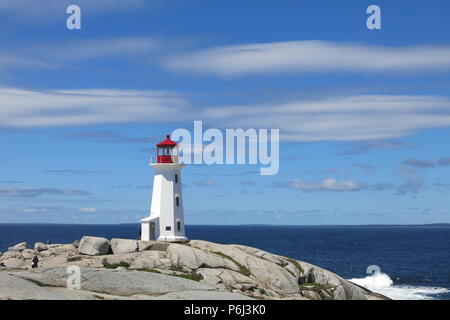 The red and white lighthouse on an outcrop of granite boulders at Peggys Cove, Nova Scotia, Canada Stock Photo