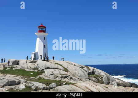 The red and white lighthouse on an outcrop of granite boulders at Peggys Cove, Nova Scotia, Canada Stock Photo