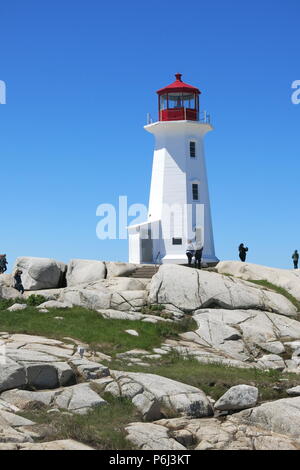 The red and white lighthouse on an outcrop of granite boulders at Peggys Cove, Nova Scotia, Canada Stock Photo