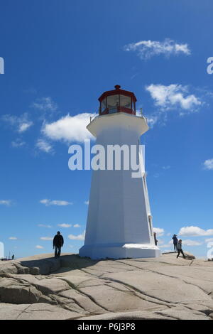 The red and white lighthouse on an outcrop of granite boulders at Peggys Cove, Nova Scotia, Canada Stock Photo