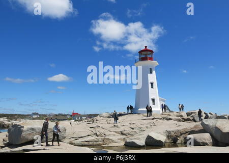 The red and white lighthouse on an outcrop of granite boulders at Peggys Cove, Nova Scotia, Canada Stock Photo