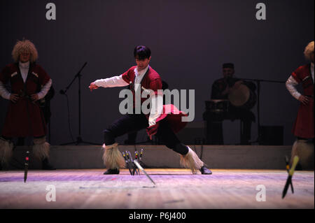 Dancers performing native Georgian dance with daggers. Sukhishvili, The Georgian National Ballet. March 10,2018. Kiev, Ukraine. Stock Photo