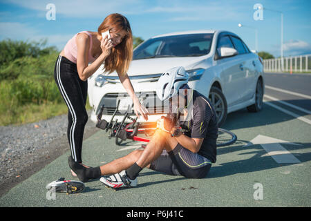 Asia cyclist injured on the street bike after collision accident car and bike. Stock Photo