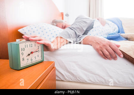 waking up stop alarm daily scene for adult woman caucasian in the morning at home. don't want to go office but retired live. lazy and tired people. cl Stock Photo
