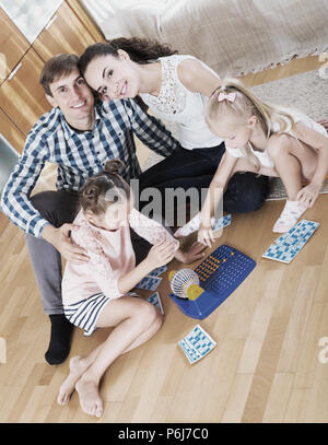 Little girls with parents trying chances at lotto game Stock Photo