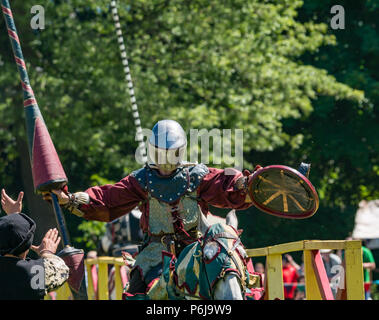 Jousting and Medieval Fair at Linlithgow Palace, Linlithgow, Scotland, United Kingdom, 30th June 2018. Historic Environment Scotland kick off their summer entertainment programme with a fabulous display of Medieval jousting in the grounds of the historic castle. The jousting is performed by Les Amis D'Onno equine stunt team. A knight riding a horse jousting Stock Photo