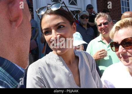 New York, NY USA. 30th. Jun, 2018. Alexandria Ocasio-Cortez, democratic primary winner who defeated powerful US Congressman Joe Crowley (D-NY)  in the New York democratic primary on 26th. June, 2018 was a crowd favorite at the #FamiliesBelongTogether rally and march to The End Family Separation NYC Rally and March in one of several similar #FamiliesBelongTogether protest events taking place across the U.S. this weekend, 30th. June, 2018. This Queens, New York march and rally, took place in the most ethnically diverse neighborhood  of the city in Jackson Heights and drew hundreds of passionate  Stock Photo